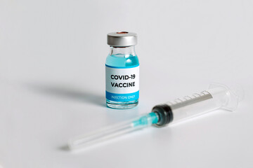 Close up of Covid-19 vaccine vial on white background. Medical vaccination concept