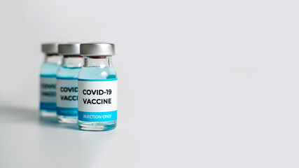 Close up of Covid-19 vaccine vials on white background. Medical vaccination concept