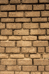 Tan Bricks Stacked Tightly into Wall