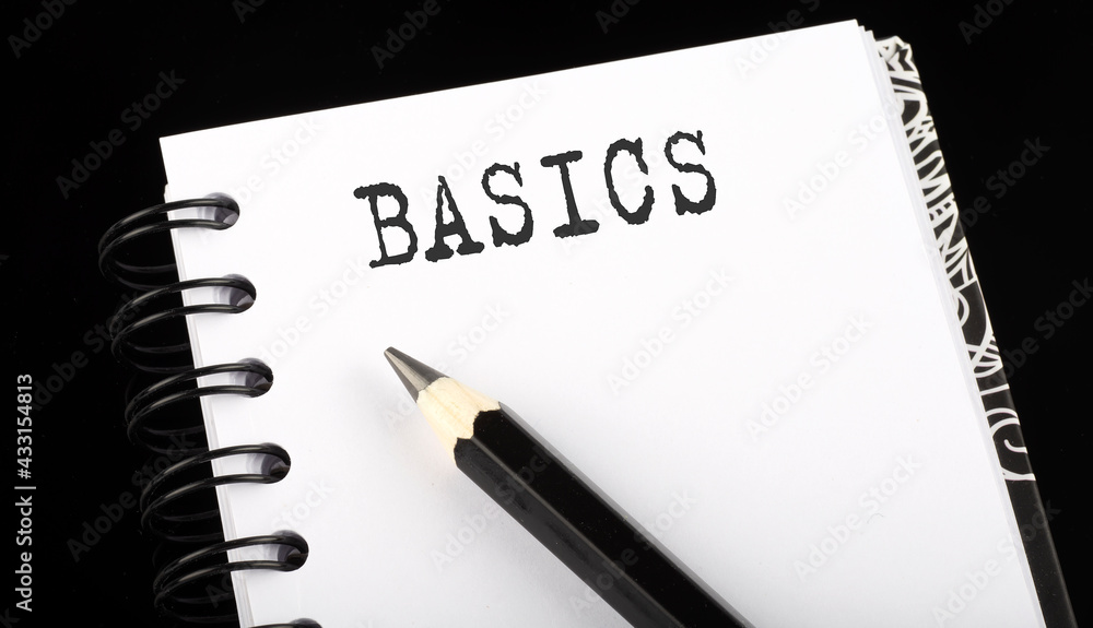 Poster basics written text in small notebook on a black background