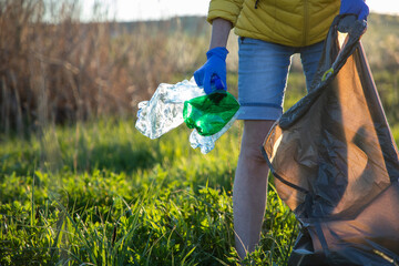 volunteer collecting plastic garbage Earth day