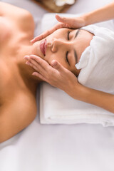 woman getting facial spa massage treatment at beauty spa salon