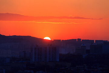 Dawn in Vladivostok. The sun will rise from behind the residential buildings.