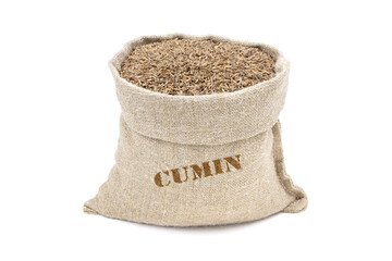Seeds of cumin in a sack isolated on a white background. Caraway seeds. Caraway in a burlap sack. Healthy food. Guianensis caraway fruit in a jute bag. Thyme.Vegan food.  - obrazy, fototapety, plakaty