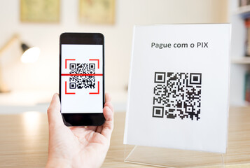 Reading a QR Code with smartphone to make a payment or transfer money via PIX.
PIX is a new...