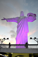 image of christ illuminated with sky in the background