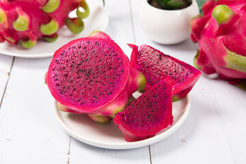 dragon fruit with half on white wood background
