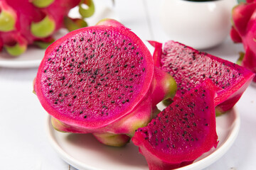 dragon fruit with half on white wood background