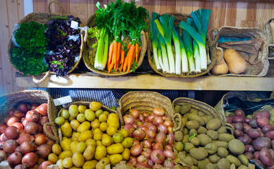Market counter with large assortment of fresh vegetables for sale
