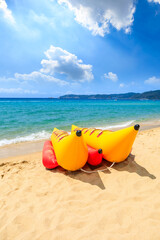 Yellow banana boat by the blue sea.