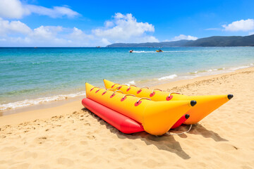Yellow banana boat by the blue sea.