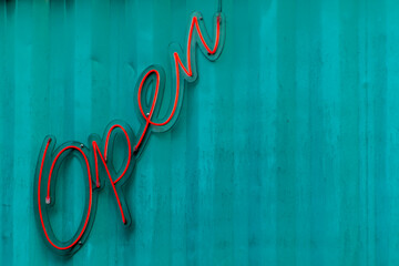 Open letter neon sign on the blue steel wall in Brazil - Powered by Adobe