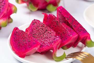dragon fruit with half on white wood background