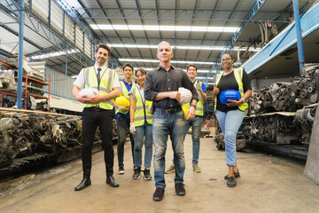 Men and woman work together, show teamwork by holding helmets and looking straight. Caucasian...