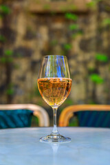 Glass of sparkling rose wine on an outdoor table with a blurred background at a vineyard in the spring in Napa Valley, California, USA