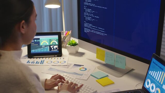 Back view young asia female people analyst coder code language multiple screen cloud online computing ai deep tech work at home office late night reskill upskill, future agile cyber ux web design job.