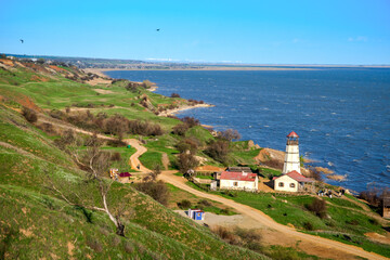 Fototapeta na wymiar Landscape, sea and lighthouse. Spring at sea