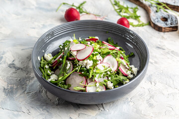 Vegetarian salad of radish, cottage cheese and arugula with sour cream. Healthy vegan food. banner, menu recipe place for text, top view
