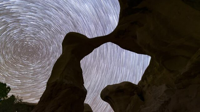 Time lapse of star trails over Metate Arch in Grand Staircase Escalante in Utah