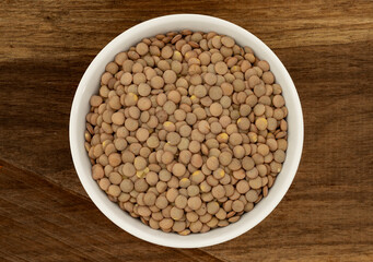 Lentils in a Ceramic Bowl. These nutritious legumes are high in protein and fiber. The image is a cut out, isolated on a white background, with a clipping path.