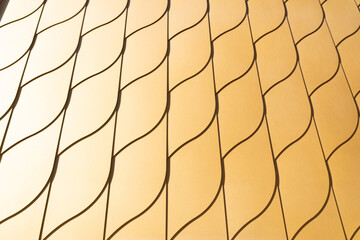 Golden metallic shining wall pattern, contemporary architectural design concept, closeup, repeating lines and shapes
