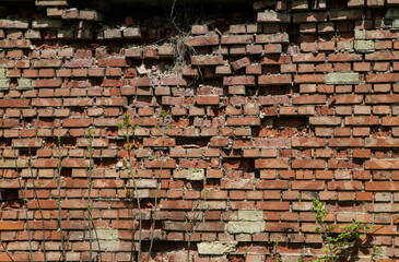 Antique red brick masonry. Partially collapsed brickwork in an old wall. Red brick texture. 