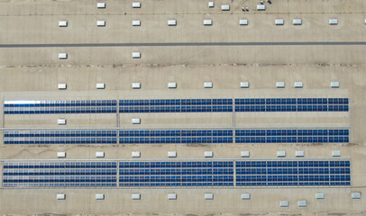 Aerial image of industrial solar panels on the roof of a hypermarket.