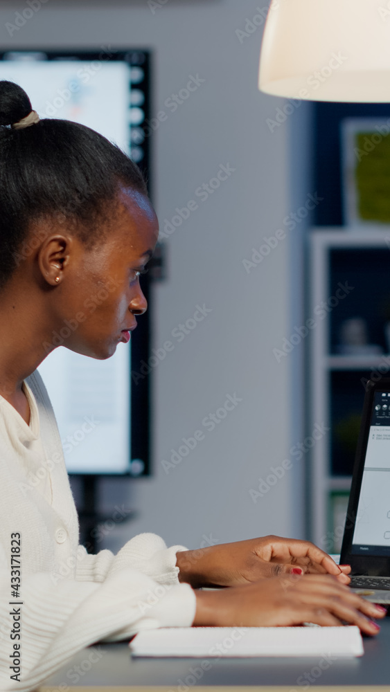 Aufkleber african architect analysing digital plans from laptop working in start-up business office overtime. 