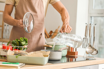 Young man cooking in kitchen