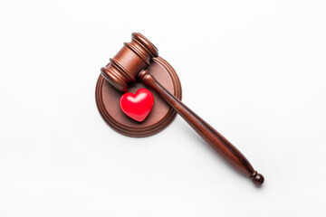 Judge's gavel and heart on white background