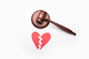 Judge's gavel and broken heart on white background