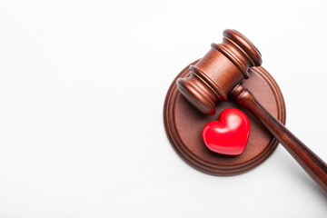 Judge's gavel and heart on white background