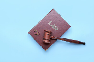 Judge's gavel with law book and rings on color background