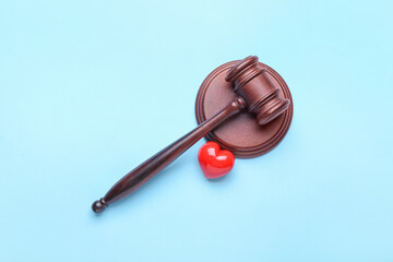 Judge's gavel and heart on color background