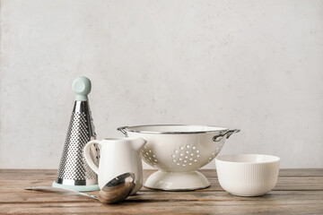 Set of kitchen utensils on light wooden background