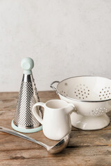 Set of kitchen utensils on light wooden background