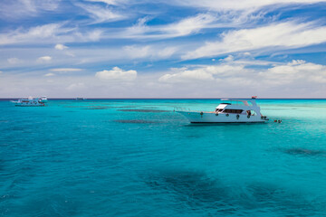 Obraz premium Cruise yacht bow in clear water near a coral reef. Red Sea, Egypt