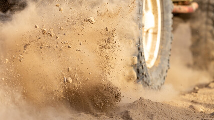 Motion the wheels tires off road dust cloud in desert, Offroad vehicle bashing through sand in the...