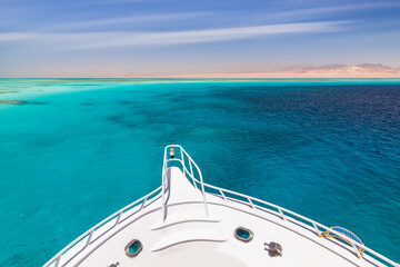 Cruise yacht bow in clear water near a coral reef. Red Sea, Egypt