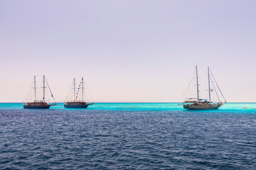Cruise yacht bow in clear water near a coral reef. Red Sea, Egypt