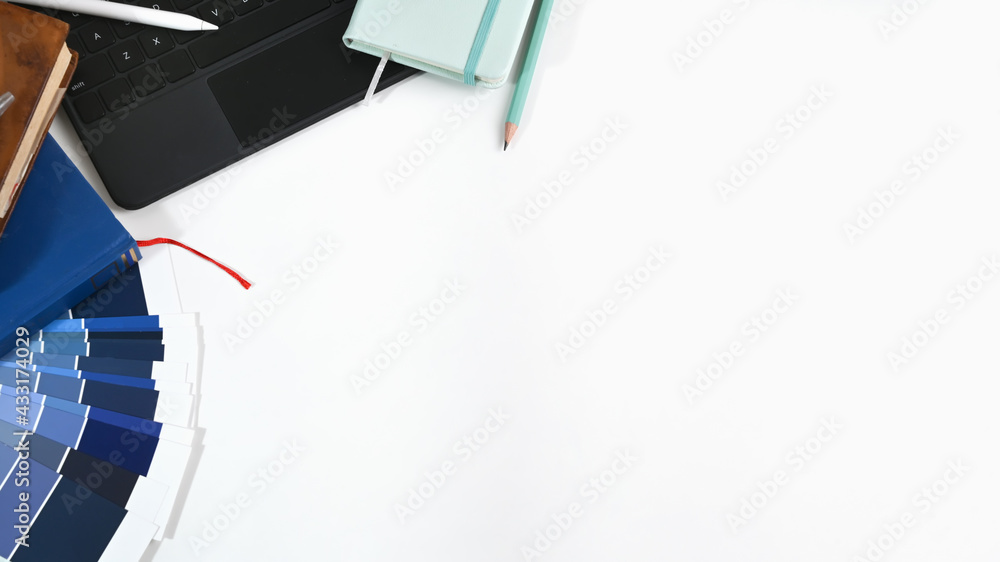 Poster top view of graphic designer workspace with computer tablet, notebook, color swatch and copy space o
