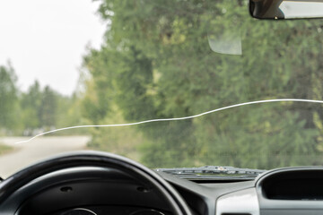 A large crack on the windshield of a vehicle in which vehicle operation is prohibited. A crack in all the glass in front of the driver and in front of the passenger.