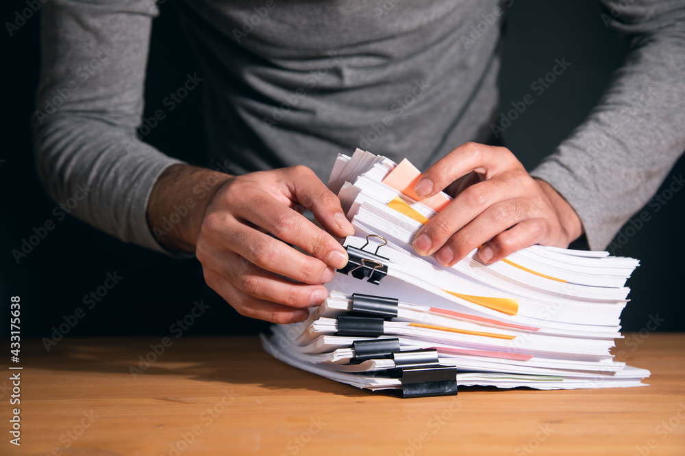Aufkleber man working in stack of paper