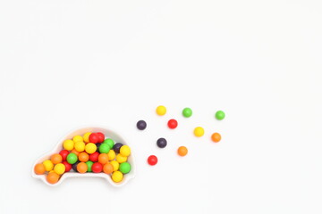 容器に入れられたカラフルなボールとこぼれたボール