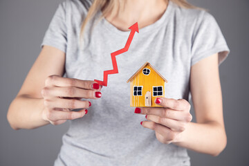 Woman holding arrow and house