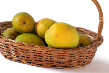 indian mangos in a basket on a white background