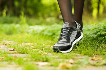 woman's legs wearing sport sneakers outdoors