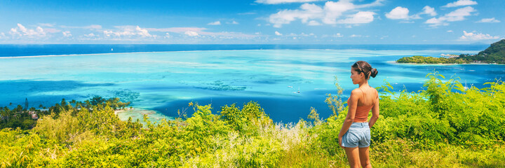 Tahiti cruise travel Moorea shore excursion tourist woman hiking on hike trail. Panoramic view...