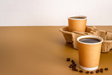 Obraz na płótnie Canvas Black coffee in paper cups with beans. Take away coffee background