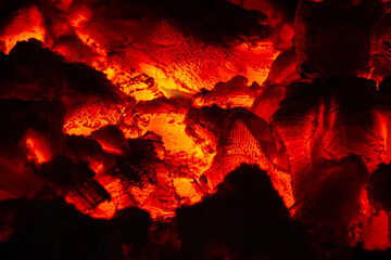 burning coals glow brightly in the dark